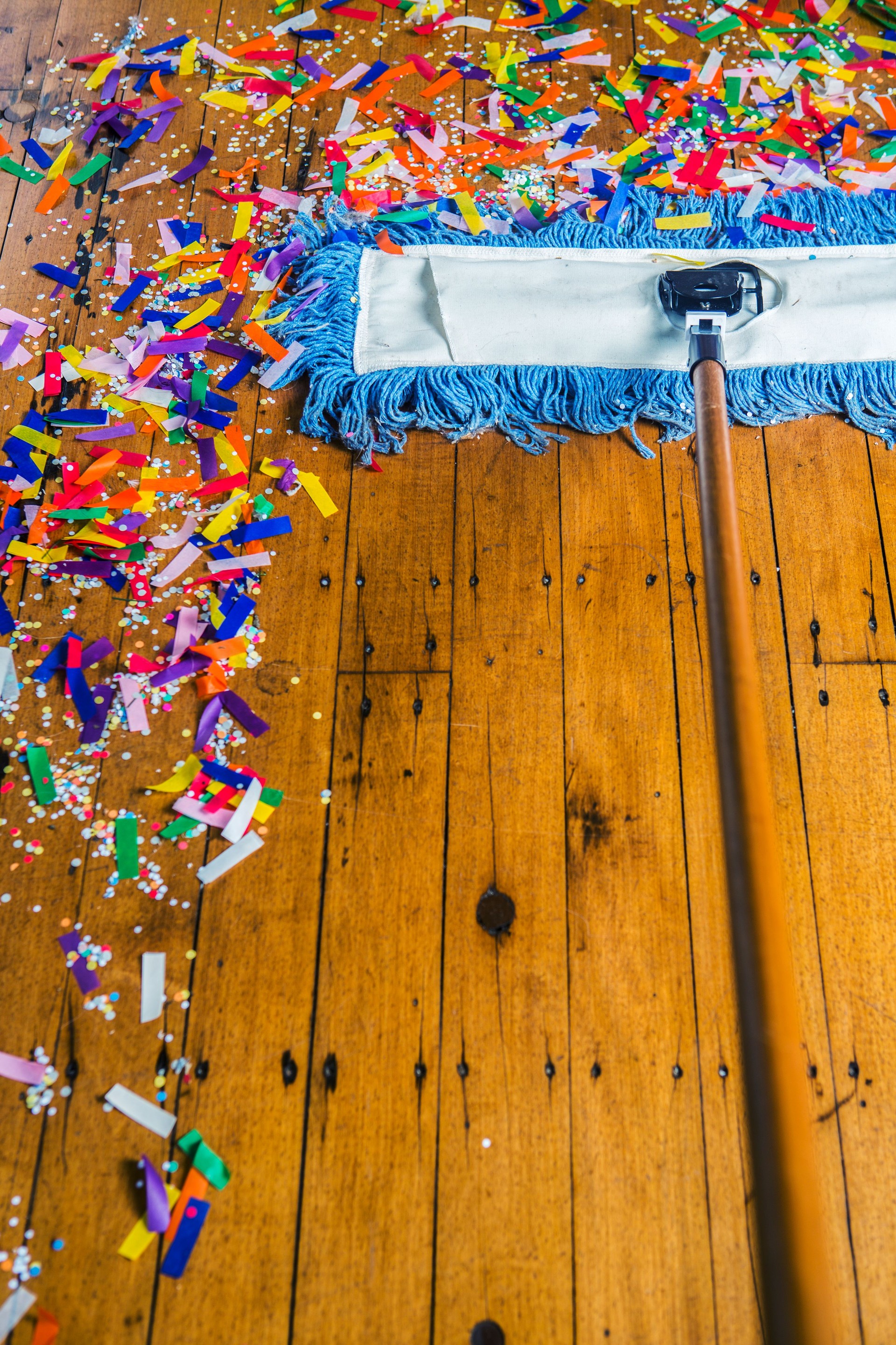 Broom sweeping up confetti
